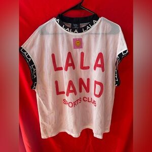 Dressed in LALA White Mesh Tee with Red Lettering